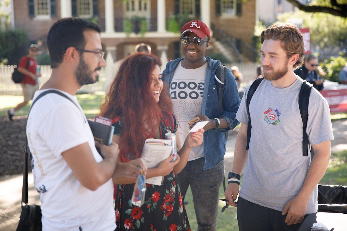 students converse in front of gorgas library